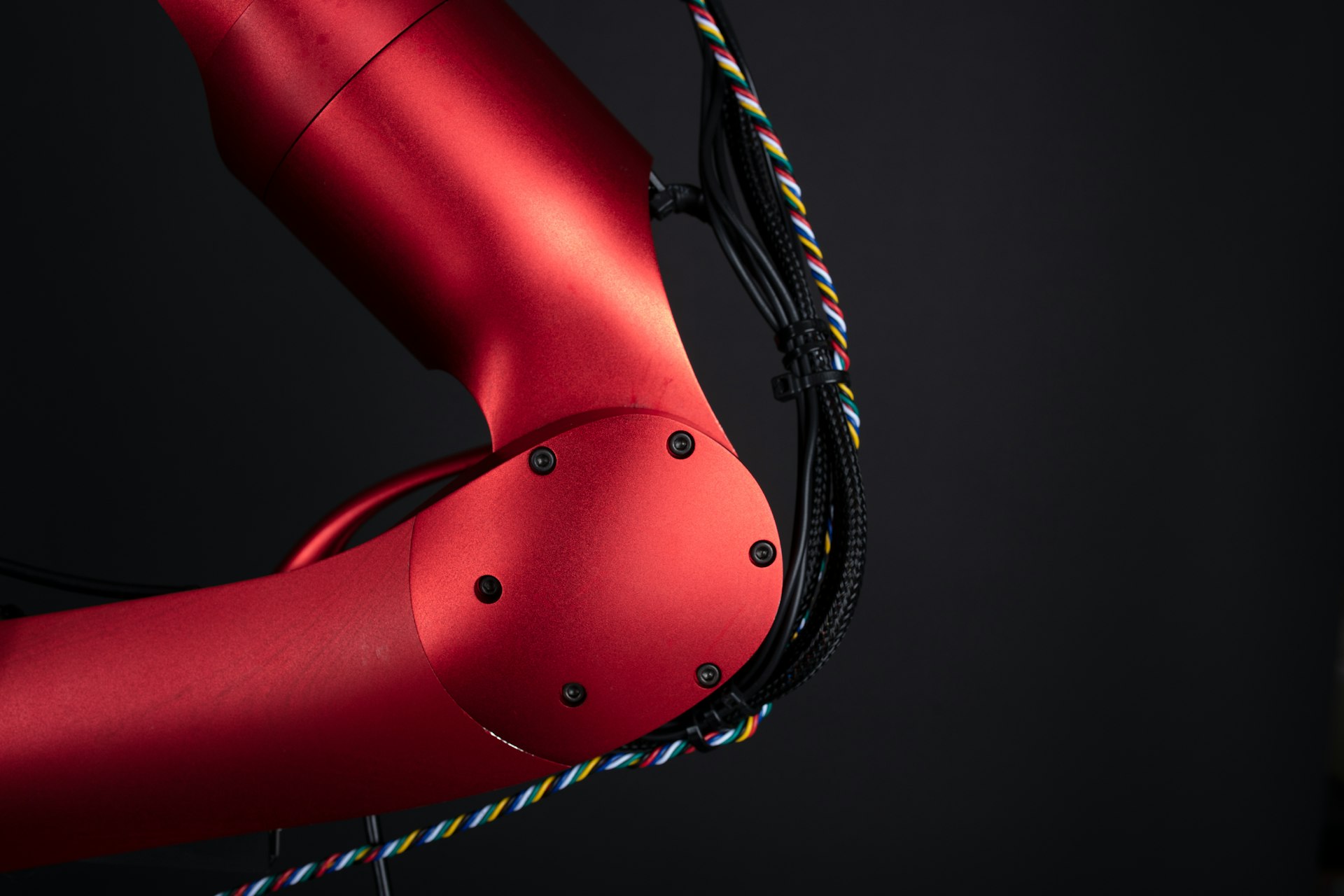 a close up of a red bike with a black background